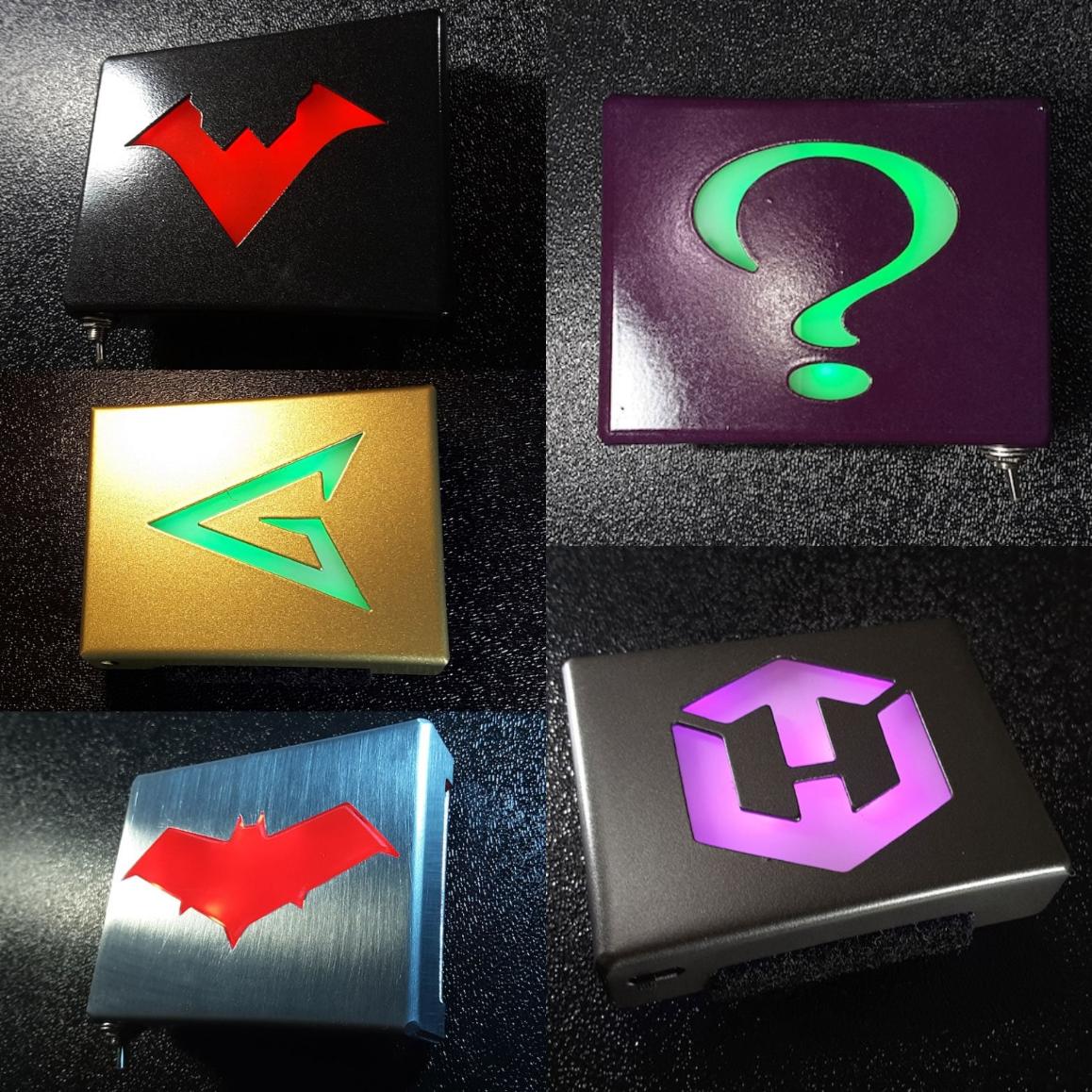 Various glowing metal belt buckles with different symbols
